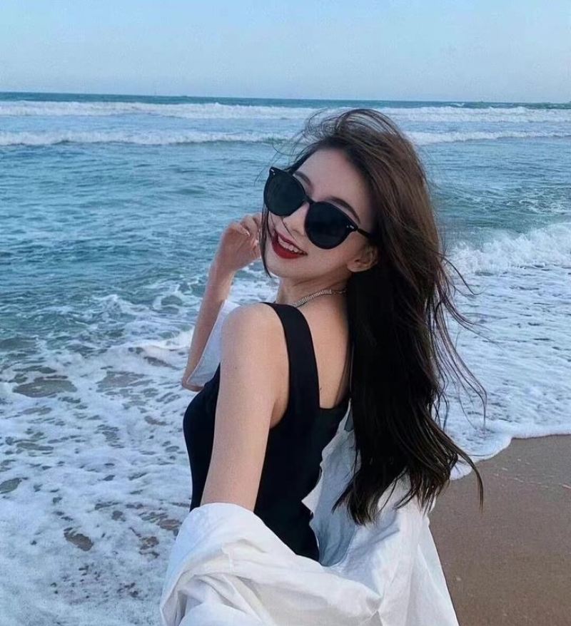 Ảnh gái xinh tóc dài đeo kính đen ở bãi biển