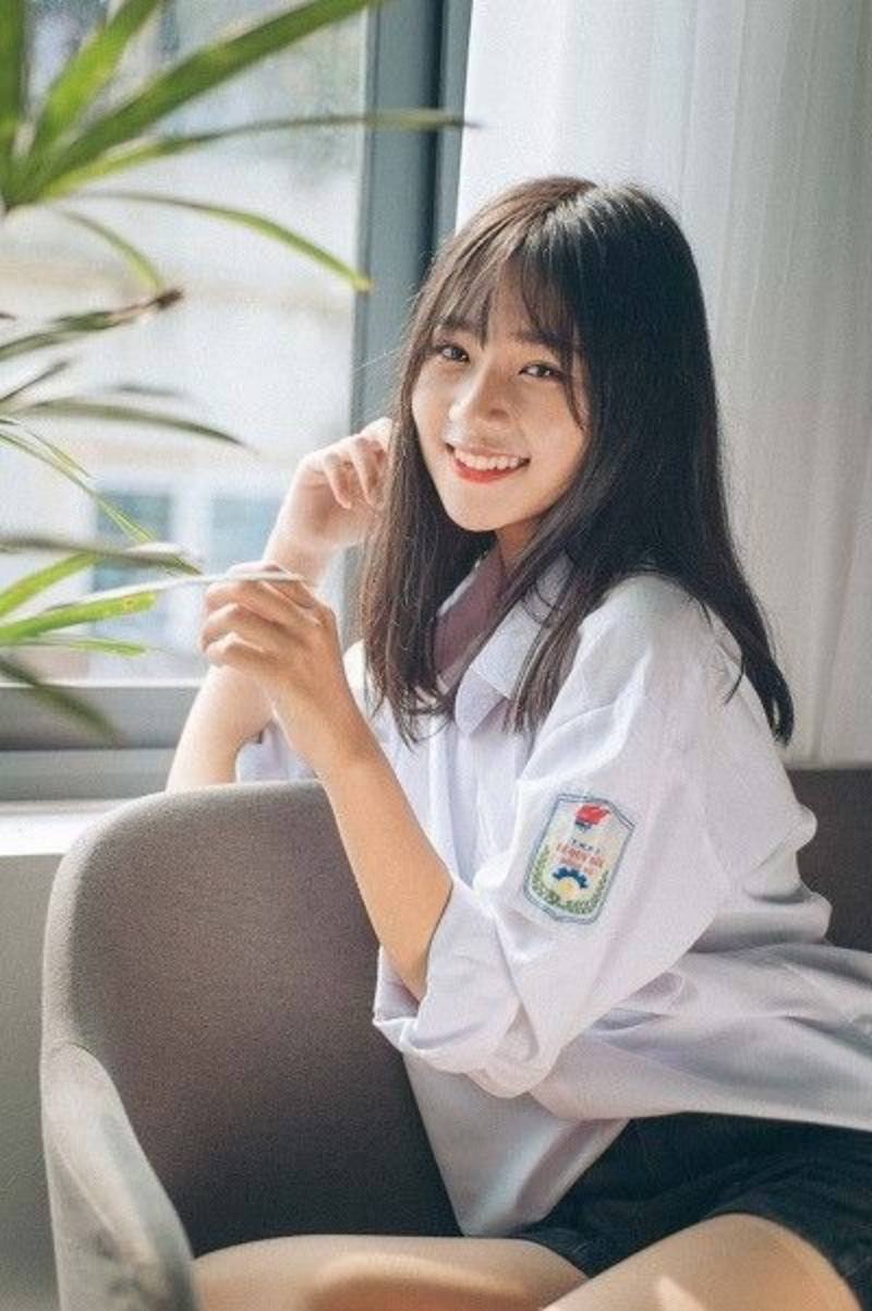Gái học sinh mặc áo sơ mi trắng ngồi trên ghế sofa Gái học sinh mặc áo sơ mi trắng ngồi trên ghế sofa